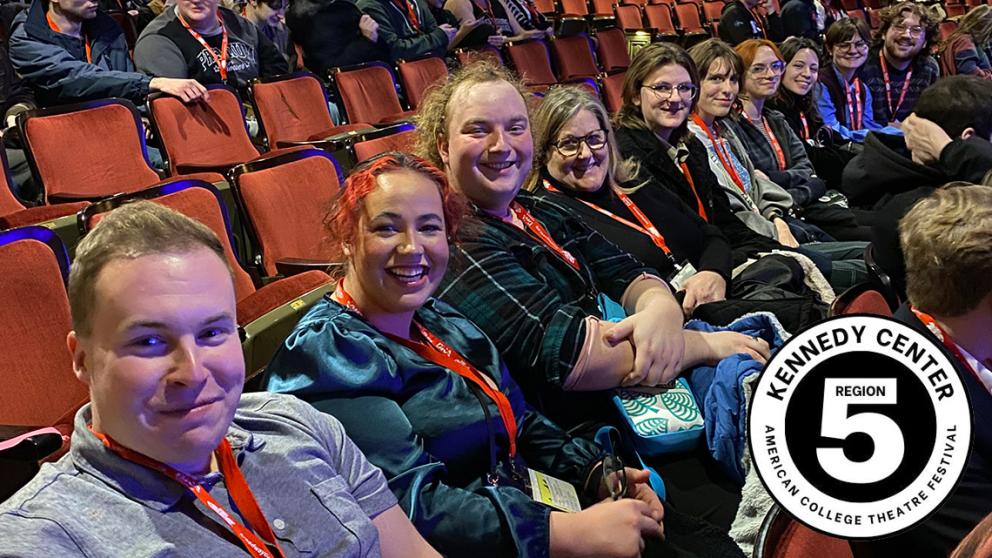 Department of Theatre & Dance contingent representing at KCACTF Region V Festival. Individuals in theatre seats in a large theatre space. Logo for KCACTF RegionV.